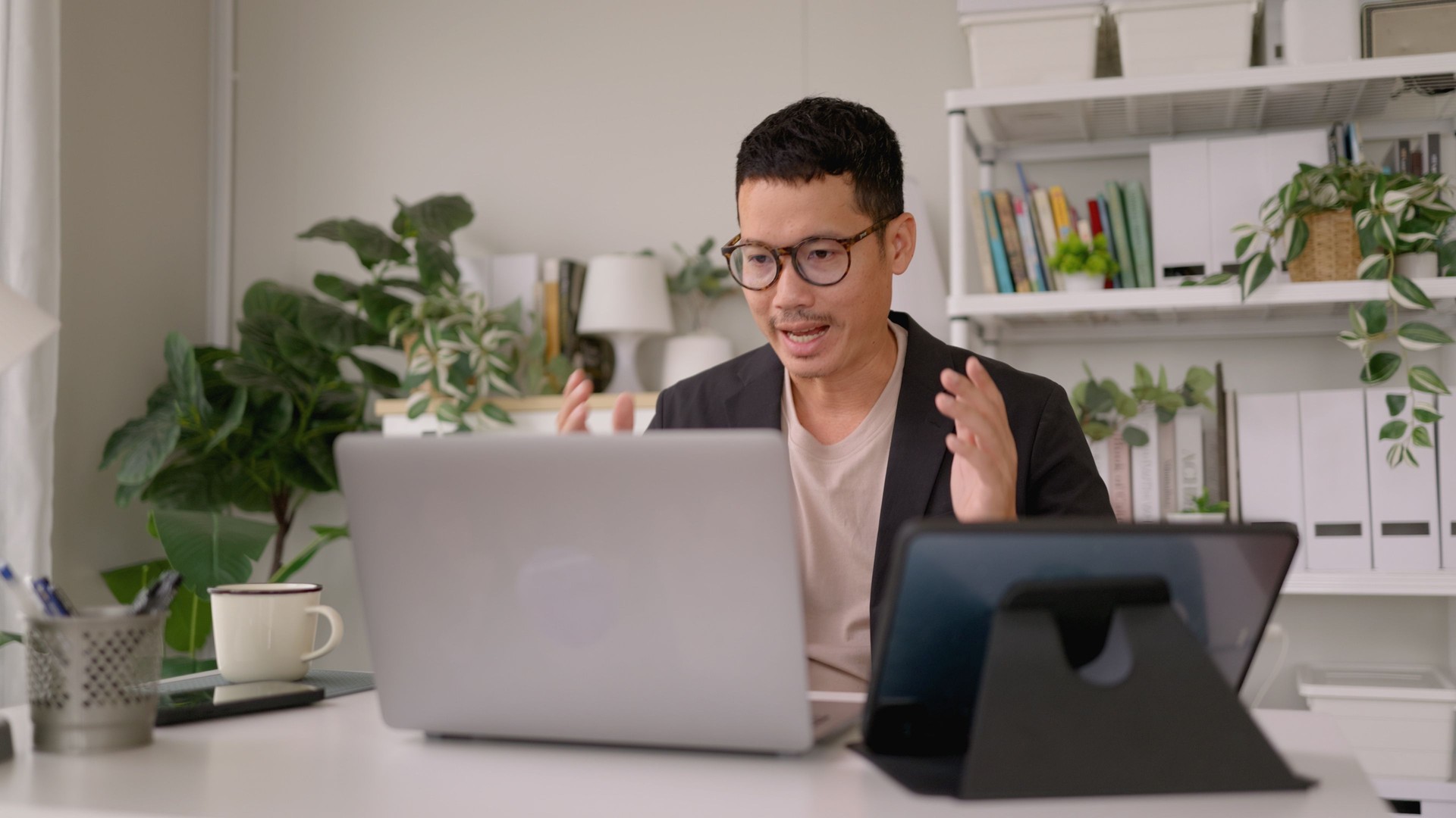 Asian man Life coach online meeting with laptop life skills and development with client. remote work and wellness building with video call for career guidance.